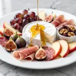 fall charcuterie board with roasted grapes and honey brie - featured image